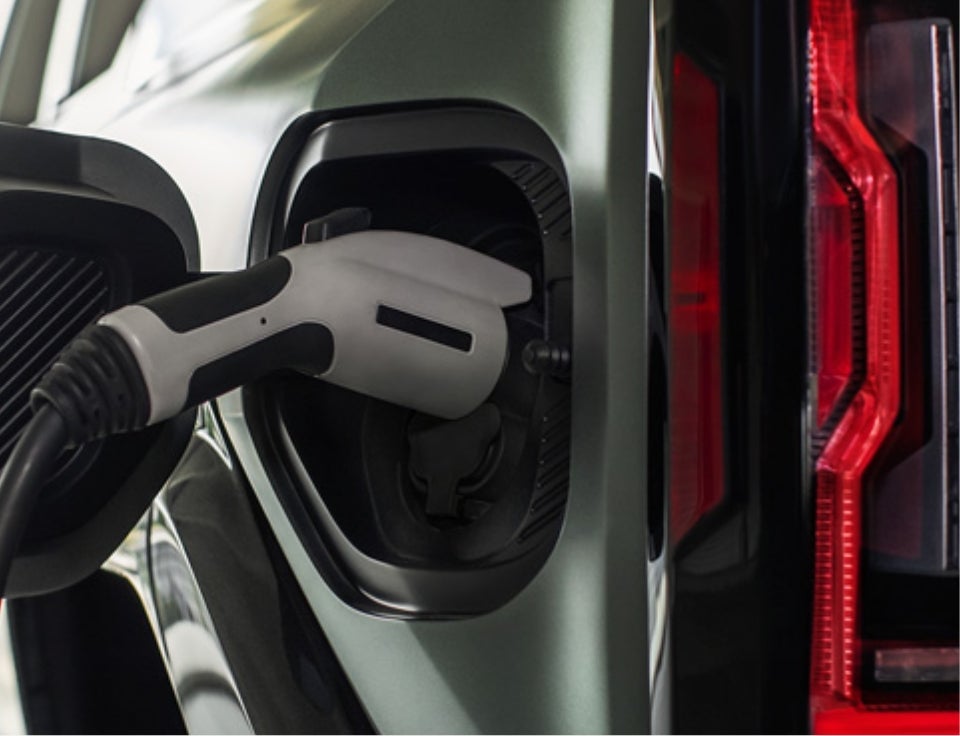 Close up of charging port with charger plugged in on a GMC Hummer EV SUV - Stephen GMC in Bristol CT