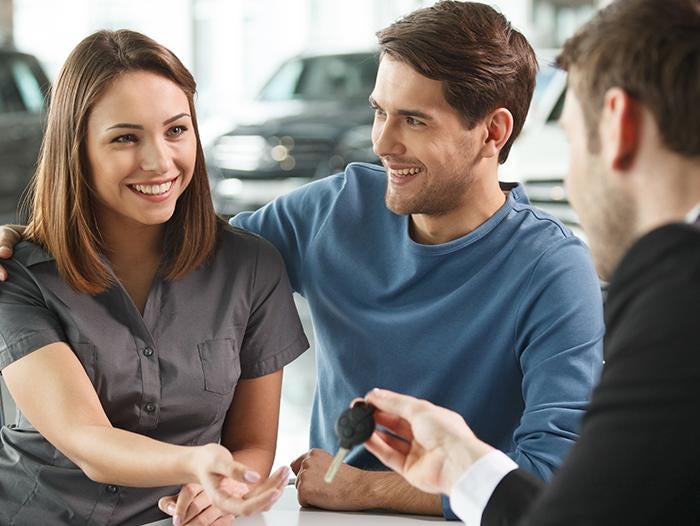 image of a couple being handed a key